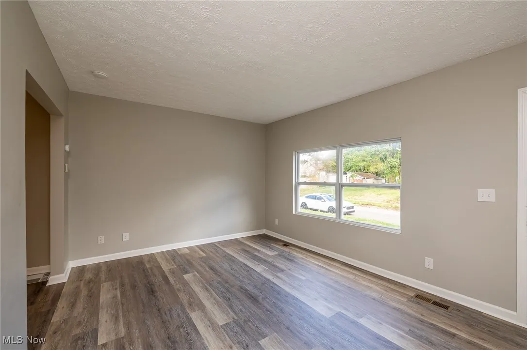 Living room featuring a textured ceiling and luxury vinyl plank floors