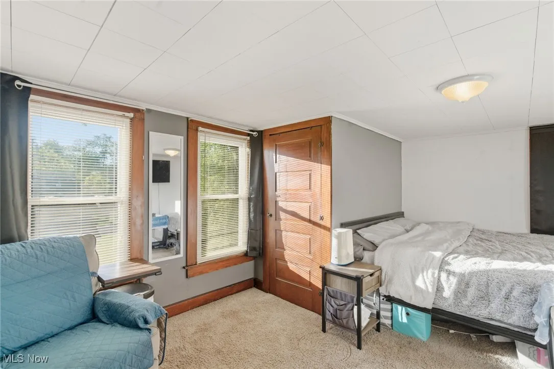 Carpeted bedroom featuring baseboards