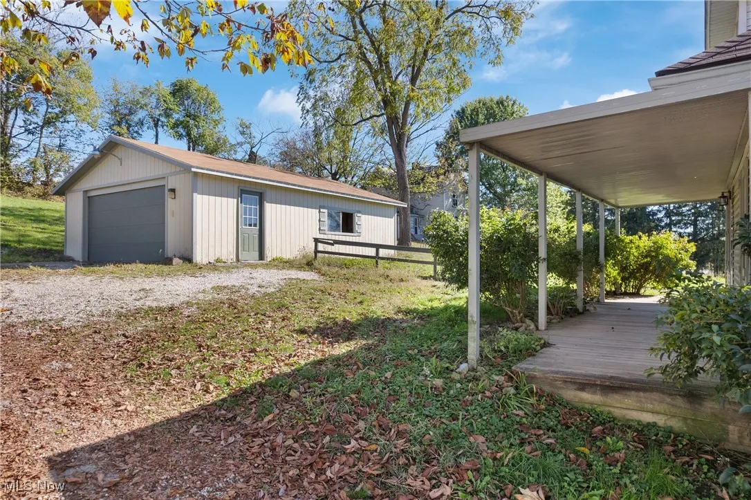 View of yard featuring a deck, and a detached garage