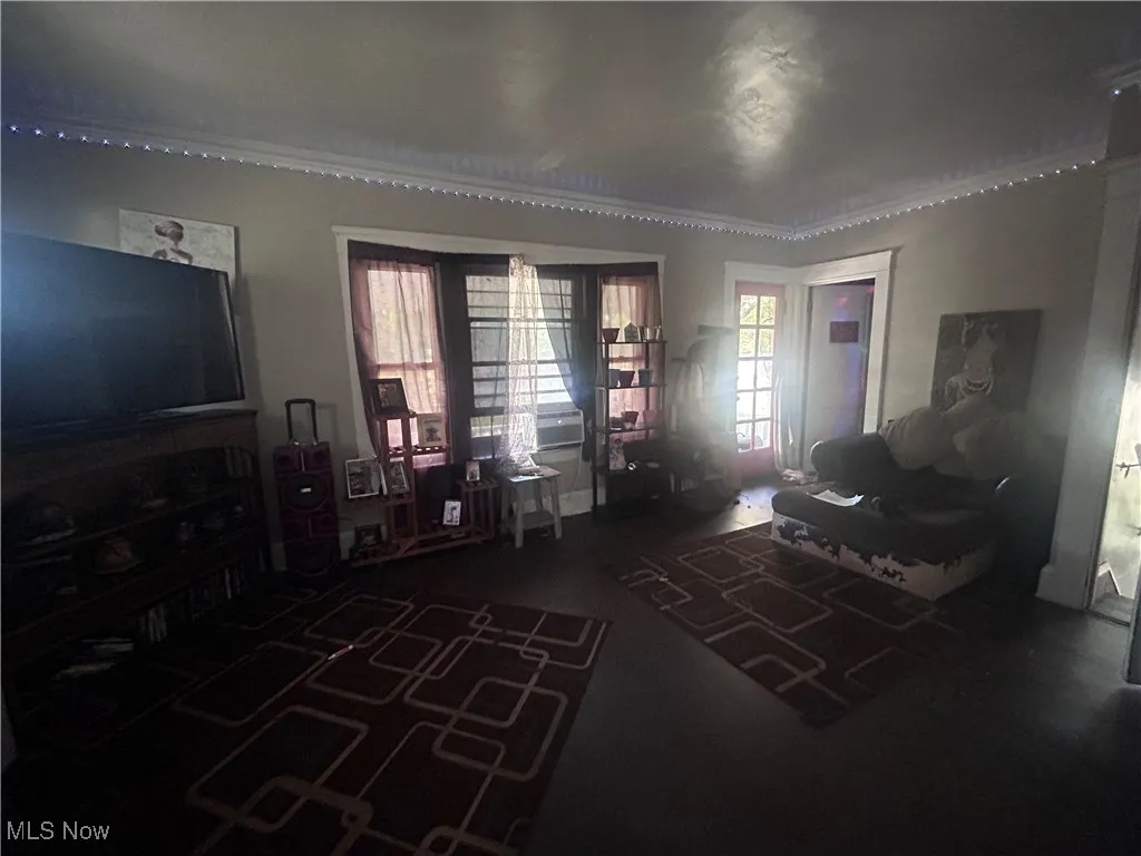 Living room featuring crown molding