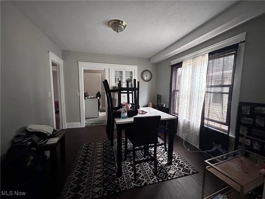 Home office featuring a textured ceiling and dark wood finished floors