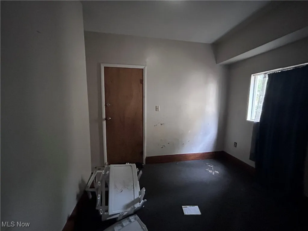 Unfurnished room featuring baseboards