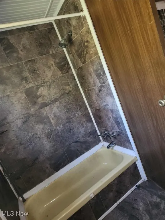 Bathroom view of tiled shower / bath combo