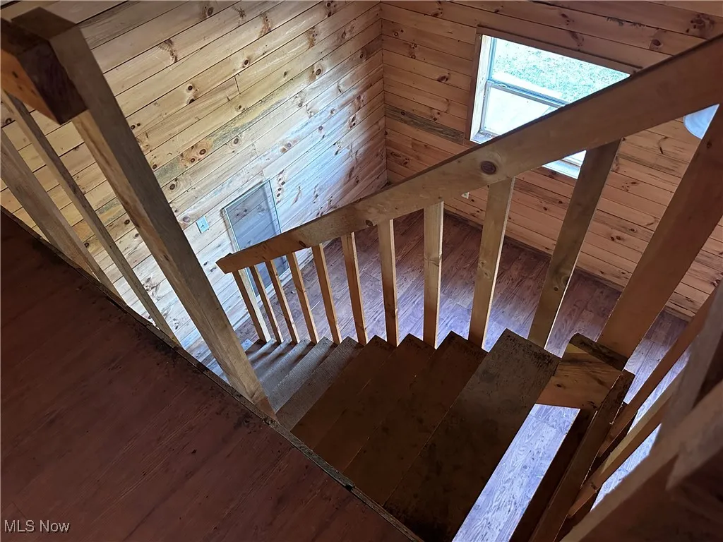 Staircase view featuring wood-type flooring
