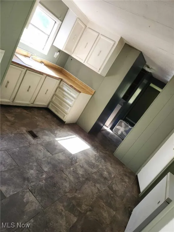 Kitchen featuring white cabinets