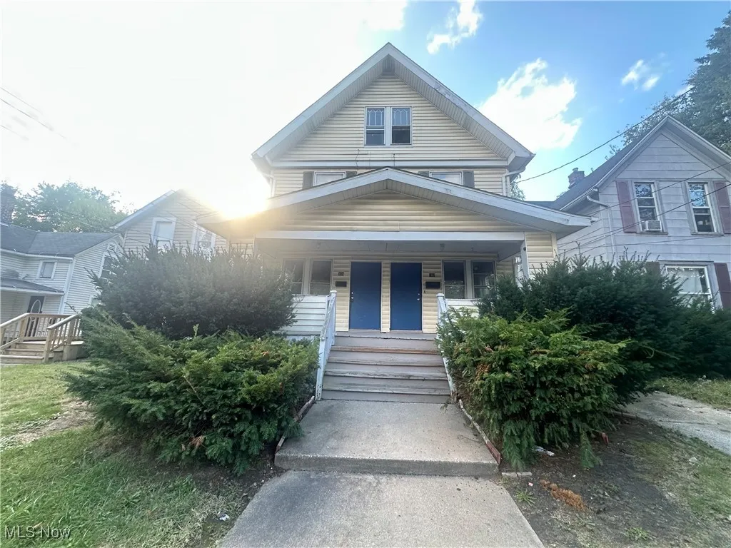 View of front of home featuring a porch and stairway
