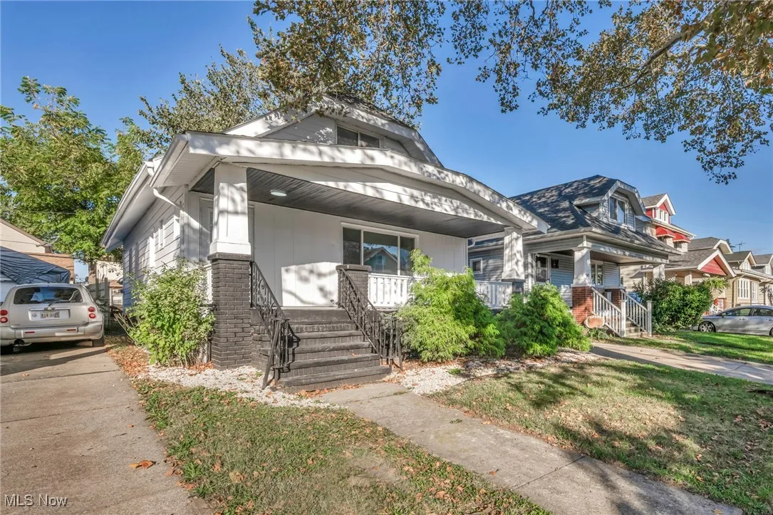 Bungalow with a porch and a front lawn
