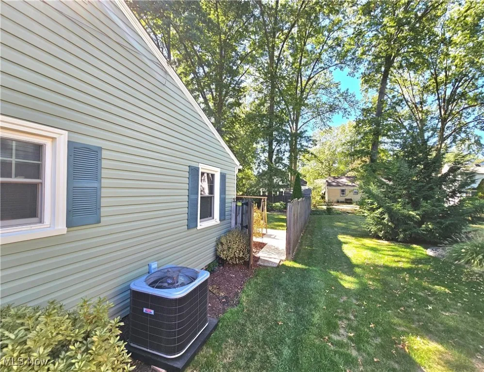 View of side of property with a cooling unit