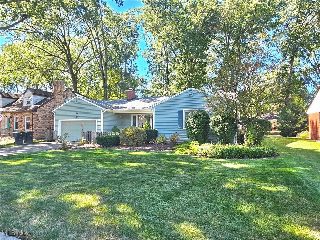 Ranch home with a front lawn and an attached garage