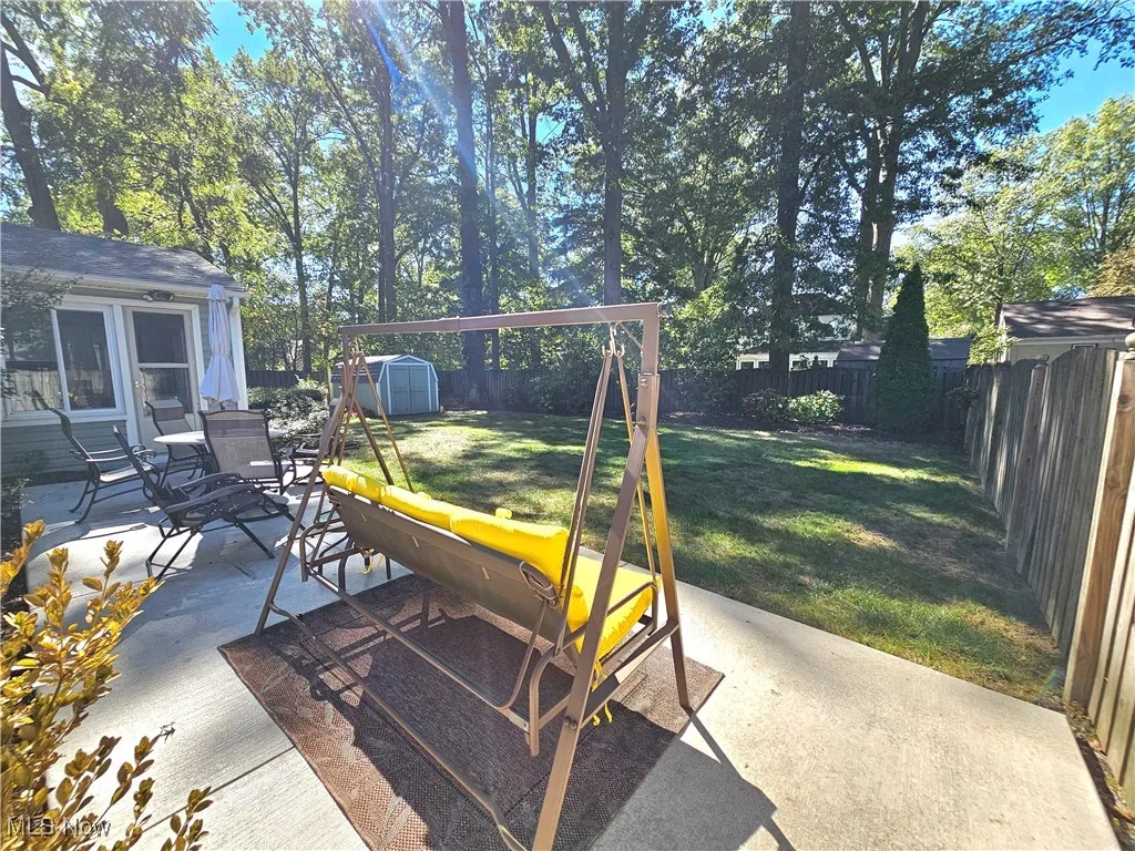 Fenced backyard with a patio area and a shed