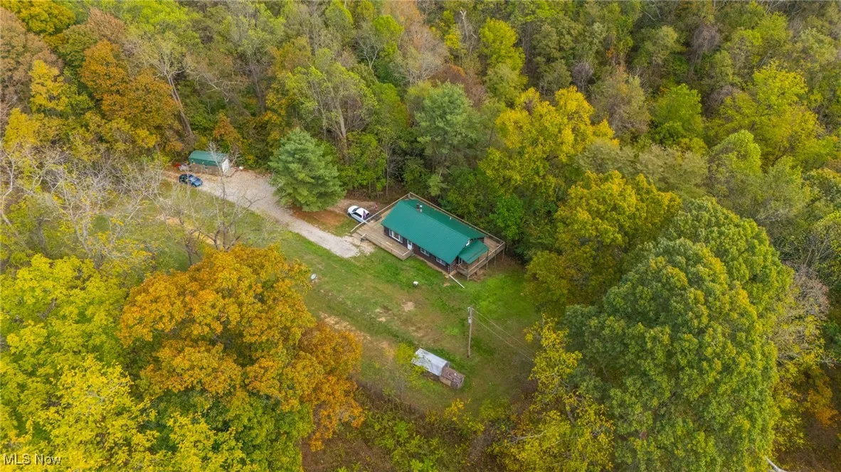 View from above of property featuring a heavily wooded area