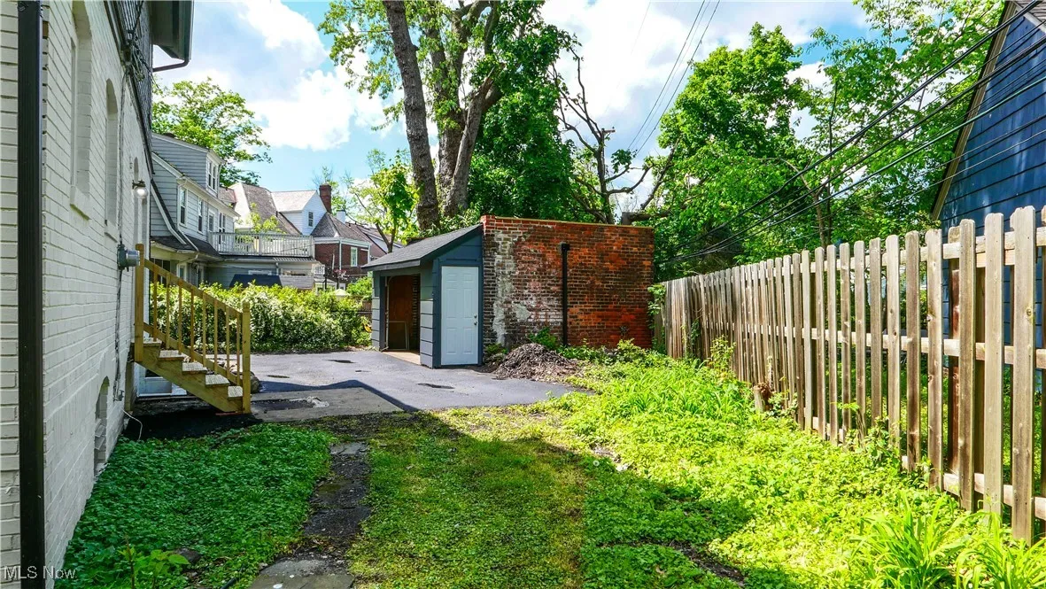 View of yard featuring a patio and a shed