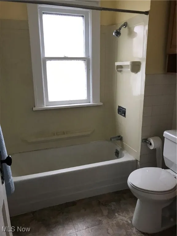 Bathroom with shower / bath combination and toilet