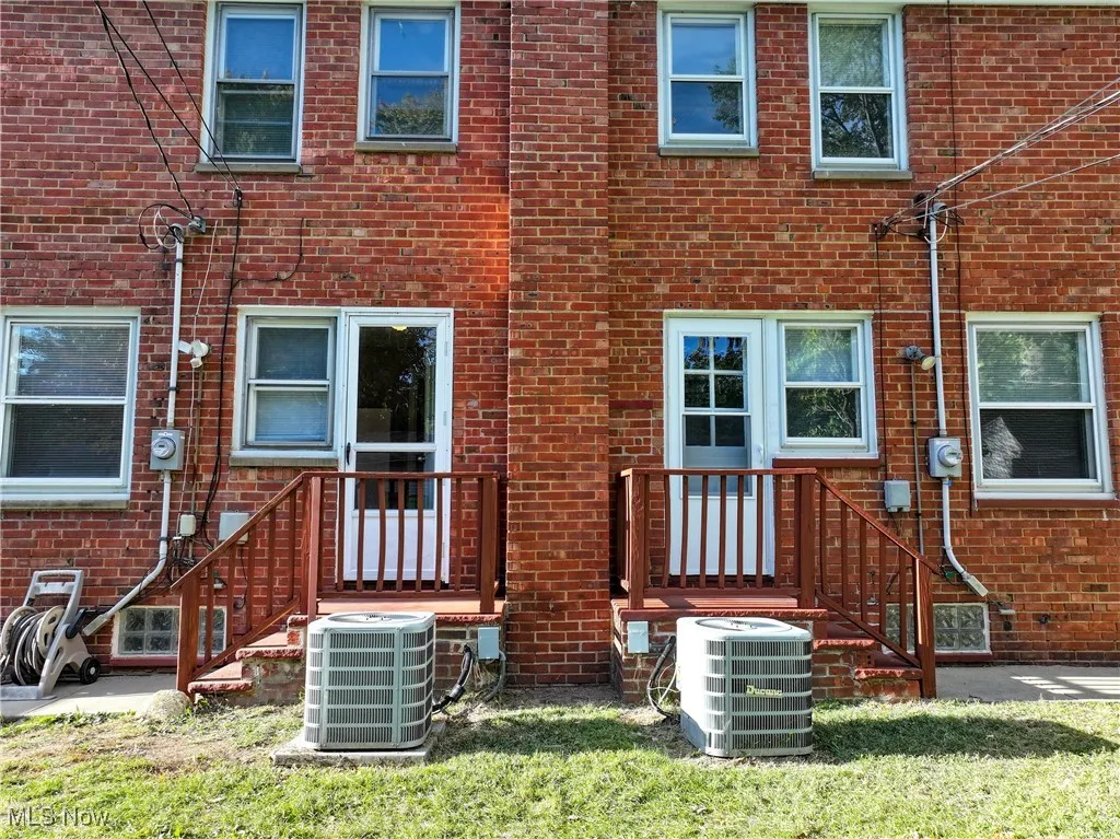 Back of home showing electrical meters and AC units
