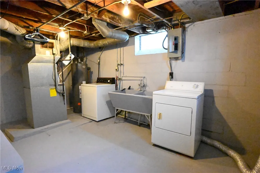 Basement of unit 1 showing furnace, slop sink, and laundry