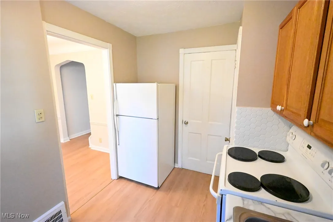 Unit 1 Kitchen with stove and sink and fridge