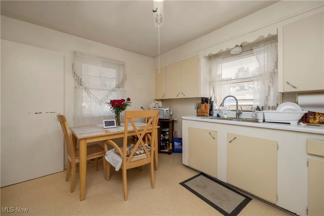 Kitchen featuring light countertops, cream cabinetry, white and light floors