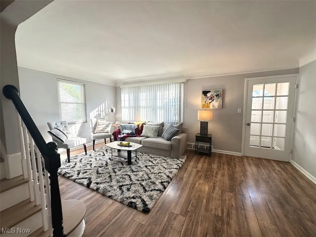 Living area featuring stairway and dark wood finished floors