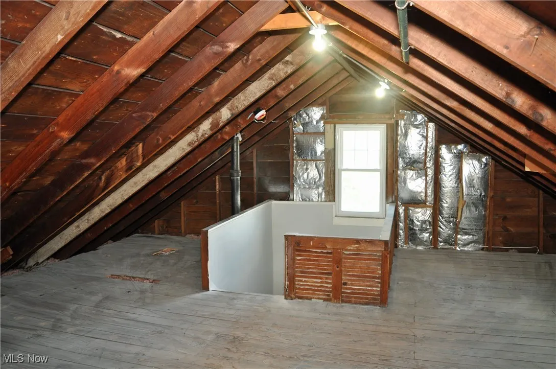 Attic featuring an upstairs landing