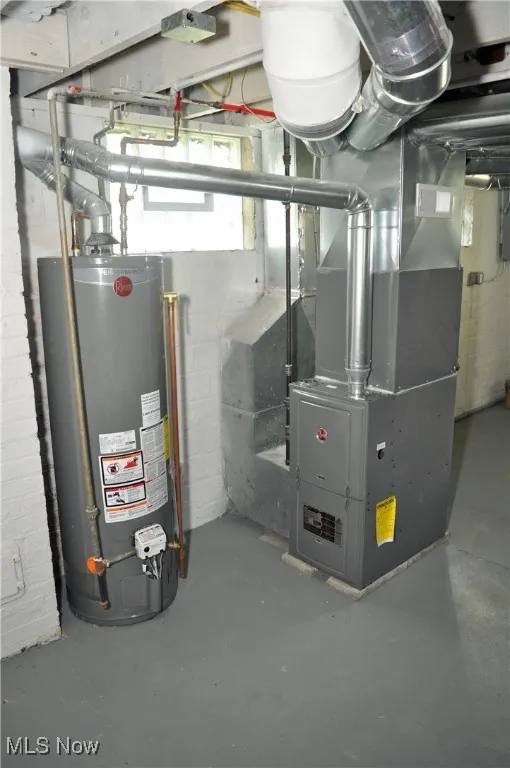 Utility room featuring gas water heater and heating unit