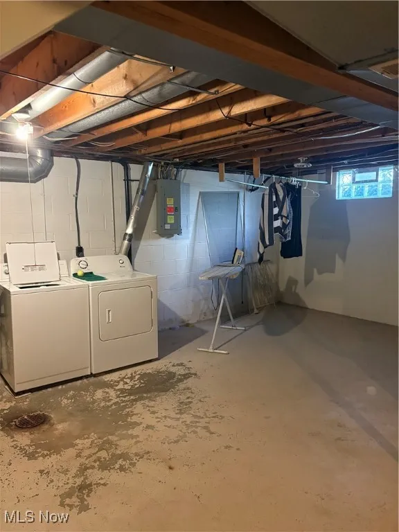 Basement with washing machine and dryer and electric panel
