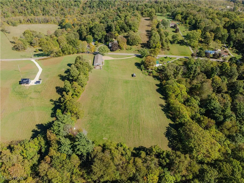Aerial view of property's location featuring a forest