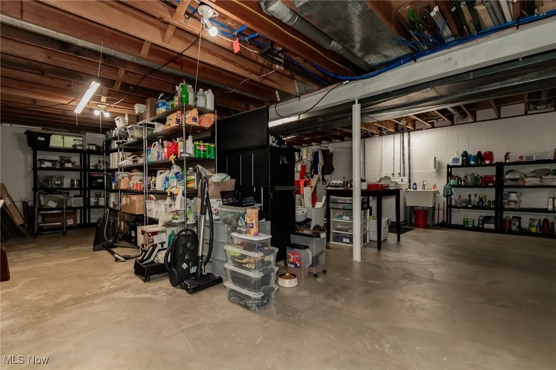 Unfinished below grade area featuring concrete block wall