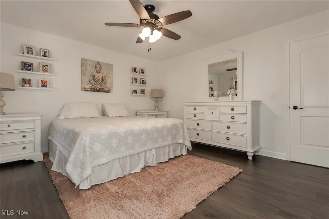 Bedroom featuring dark wood-type flooring and a ceiling fan