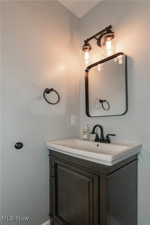 Bathroom featuring vanity and baseboards