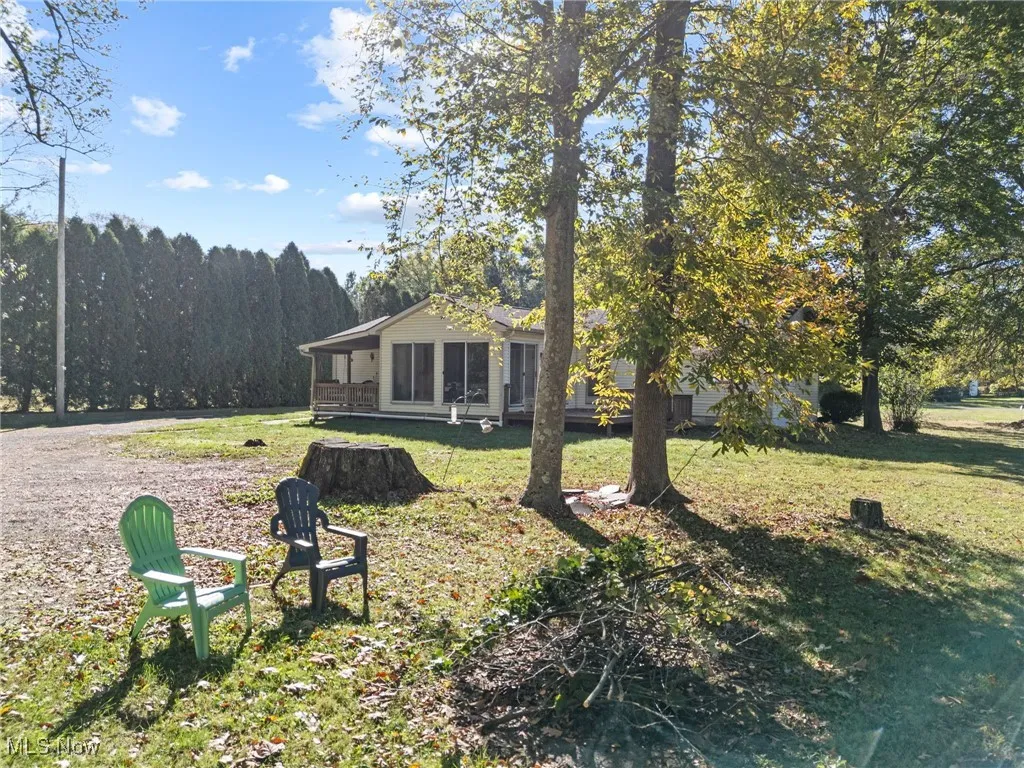 View of green lawn with a sunroom