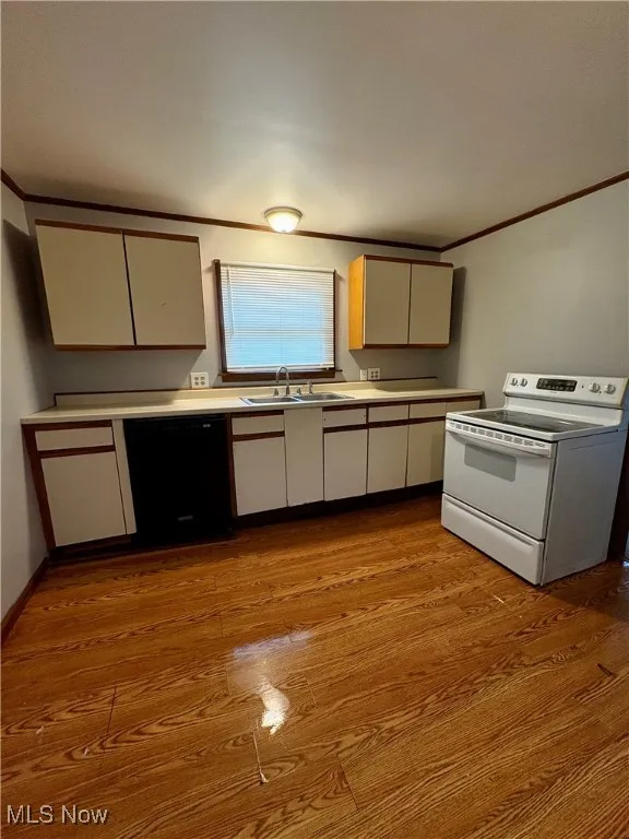 Kitchen with ornamental molding, electric stove, light countertops, dishwasher, and light wood finished floors
