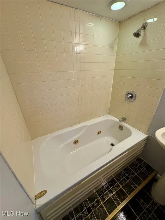 Bathroom with tub / shower combination and tile patterned floors