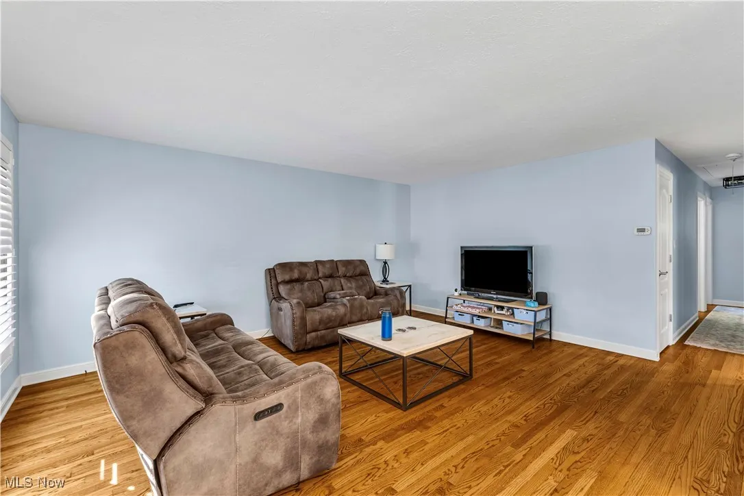 Living room with light wood-style floors and baseboards