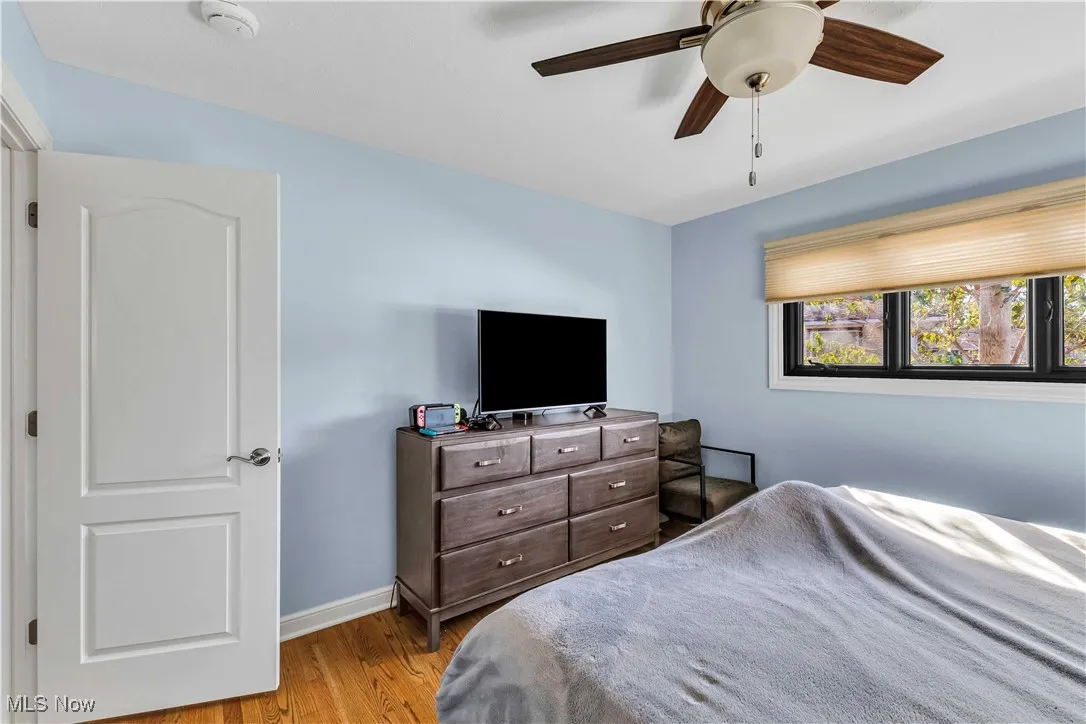 Bedroom with wood finished floors and a ceiling fan