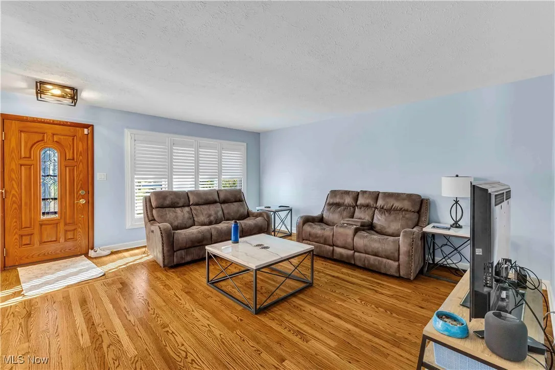 Living area with a textured ceiling and wood finished floors