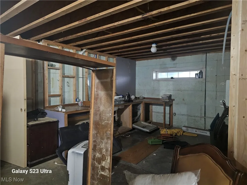 Bonus room featuring wooden ceiling, wood finished floors, wood walls, and ceiling fan