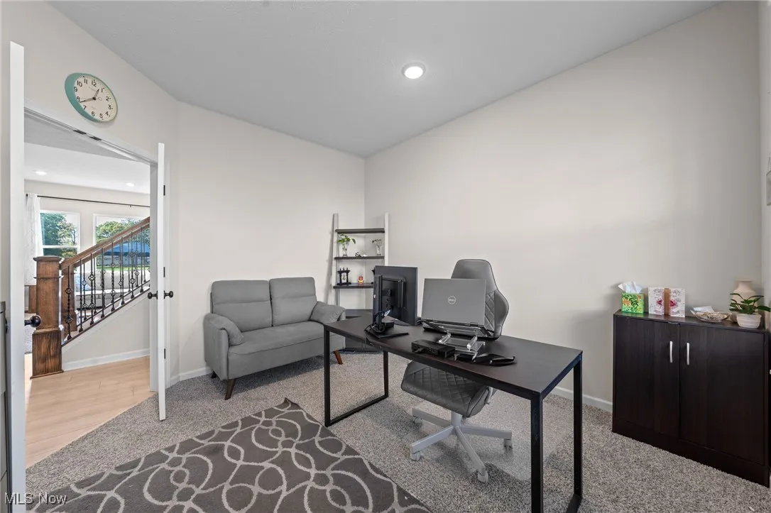 Office area featuring light carpet and recessed lighting