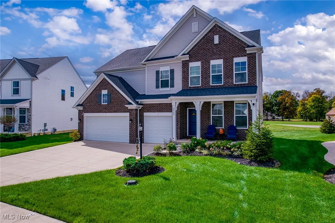 View of front of property featuring a front yard and brick siding