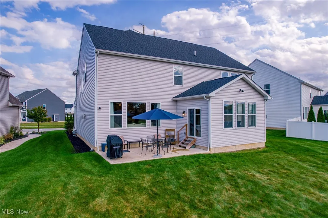 Back of property featuring a patio, roof with shingles, and entry steps