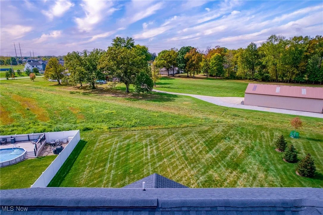 View of green lawn featuring an outbuilding