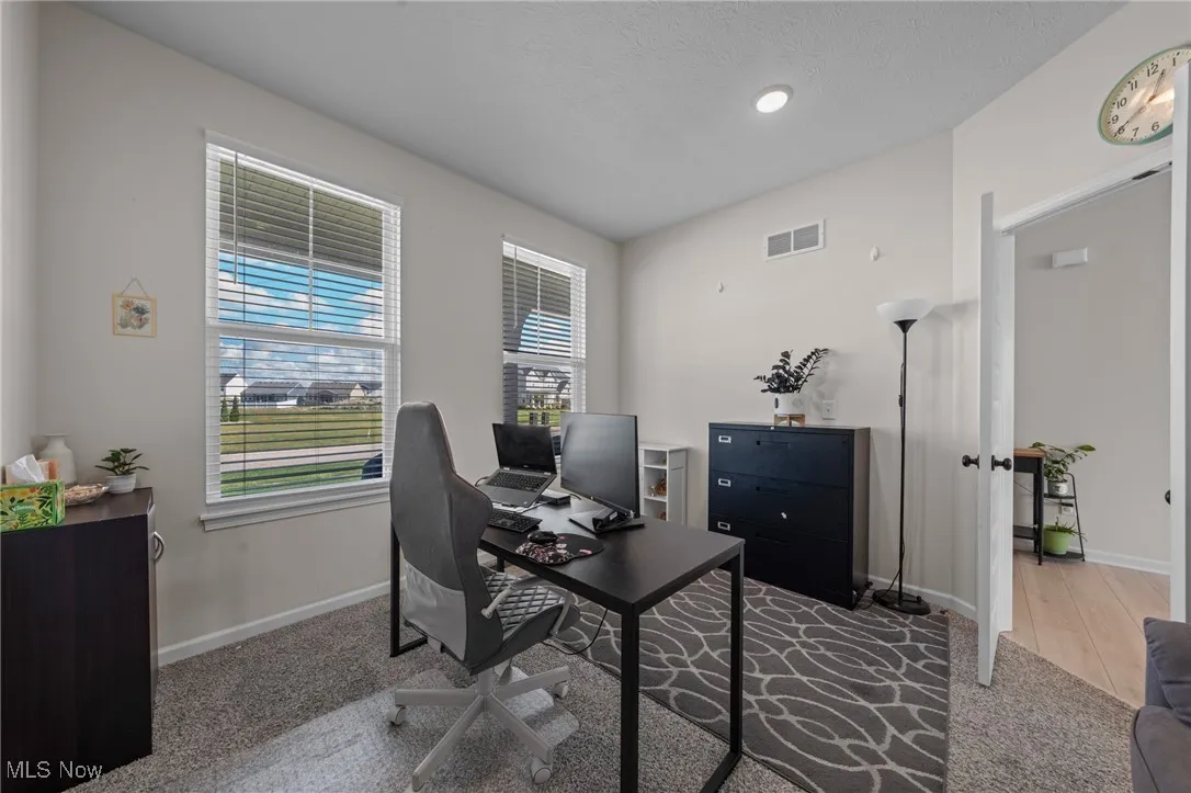 Home office with carpet floors and baseboards