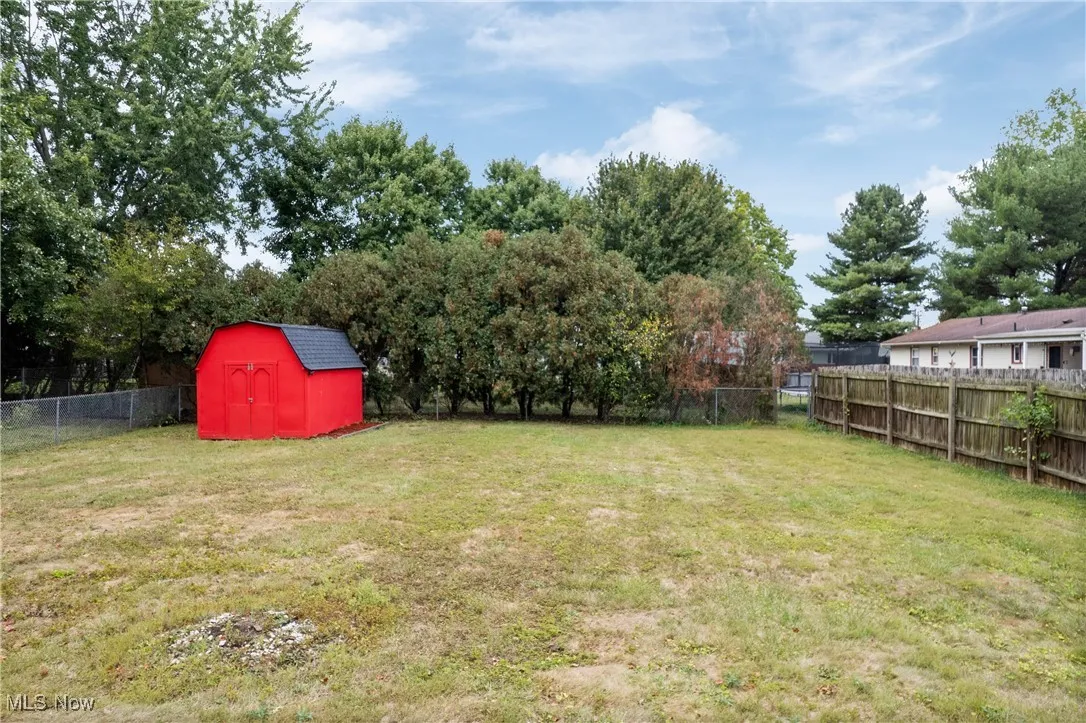 Fenced backyard with a storage shed