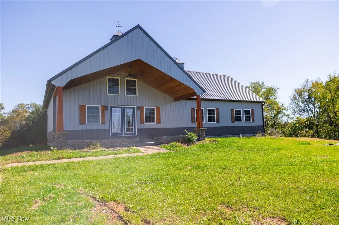 View of front of property with a front lawn and covered porch