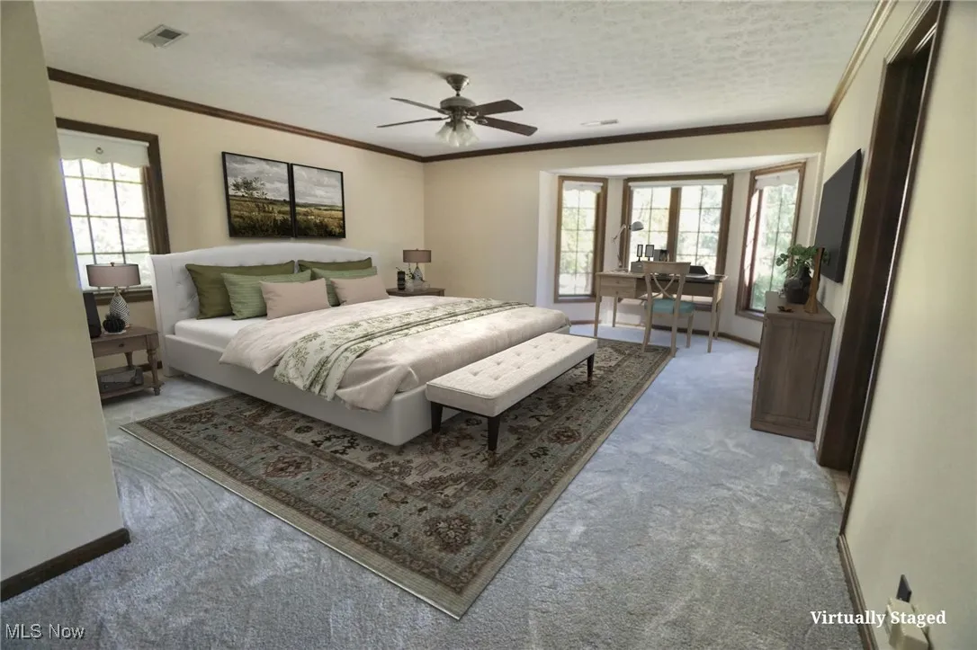 Bedroom with crown molding, carpet, a desk, and ceiling fan