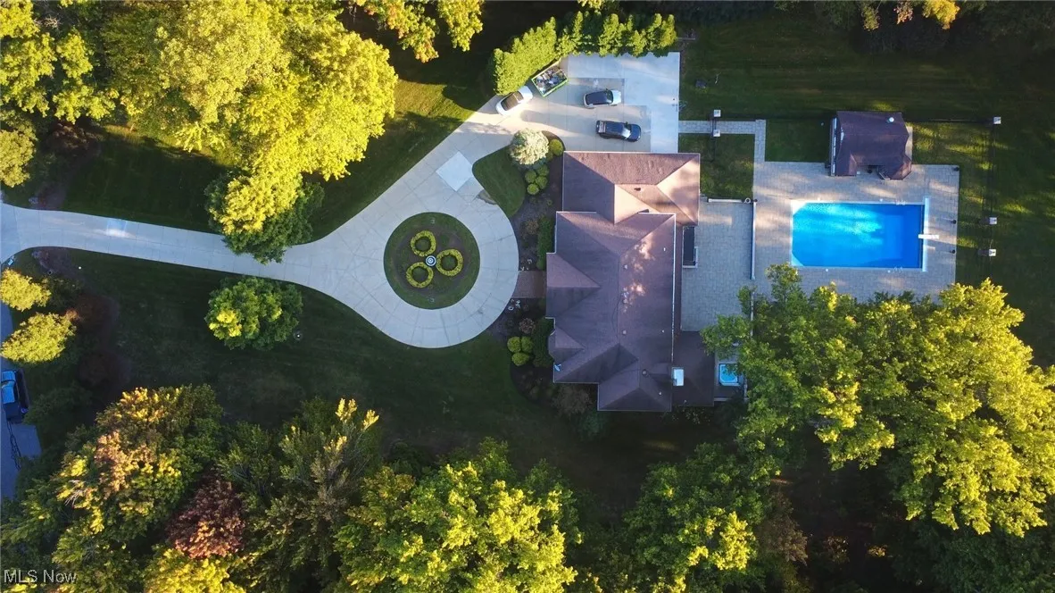Aerial view of property and surrounding area with a pool area