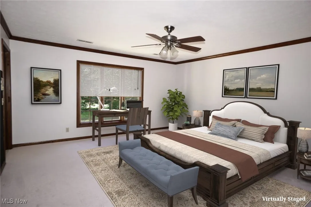 Bedroom with crown molding, a ceiling fan, and carpet flooring