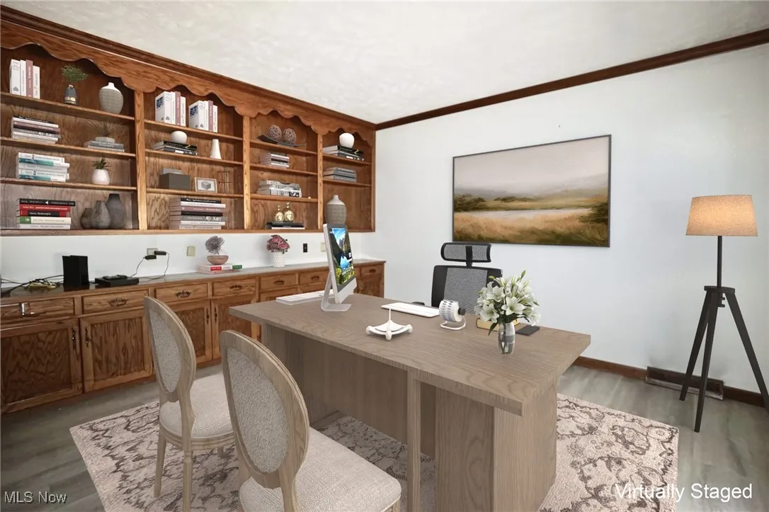 Office featuring light wood-style flooring and crown molding