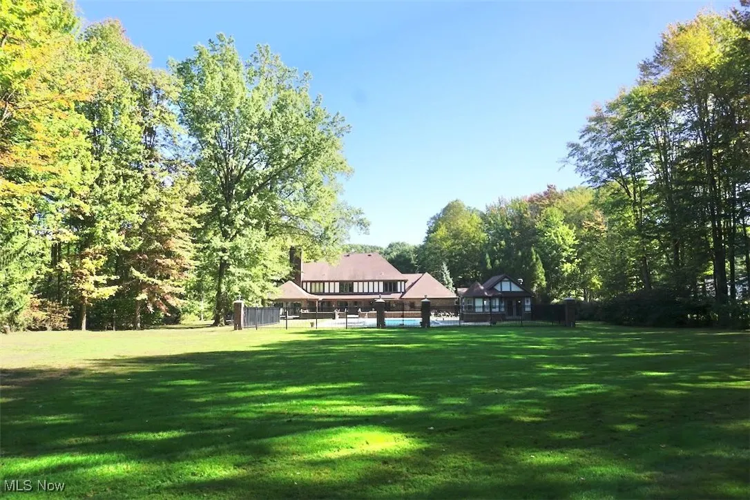 View of rear yard, leading up to the fenced pool area.