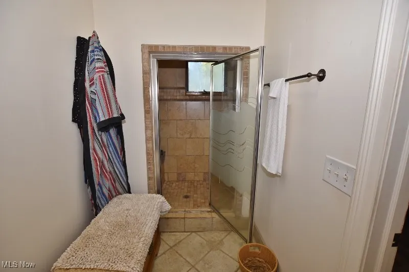This primary bedroom features a beautiful private tiled shower