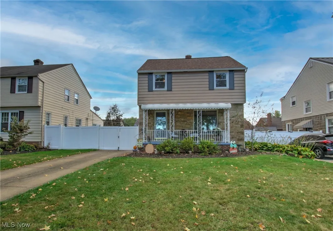 View of front of house featuring a gate, a porch, and stone siding